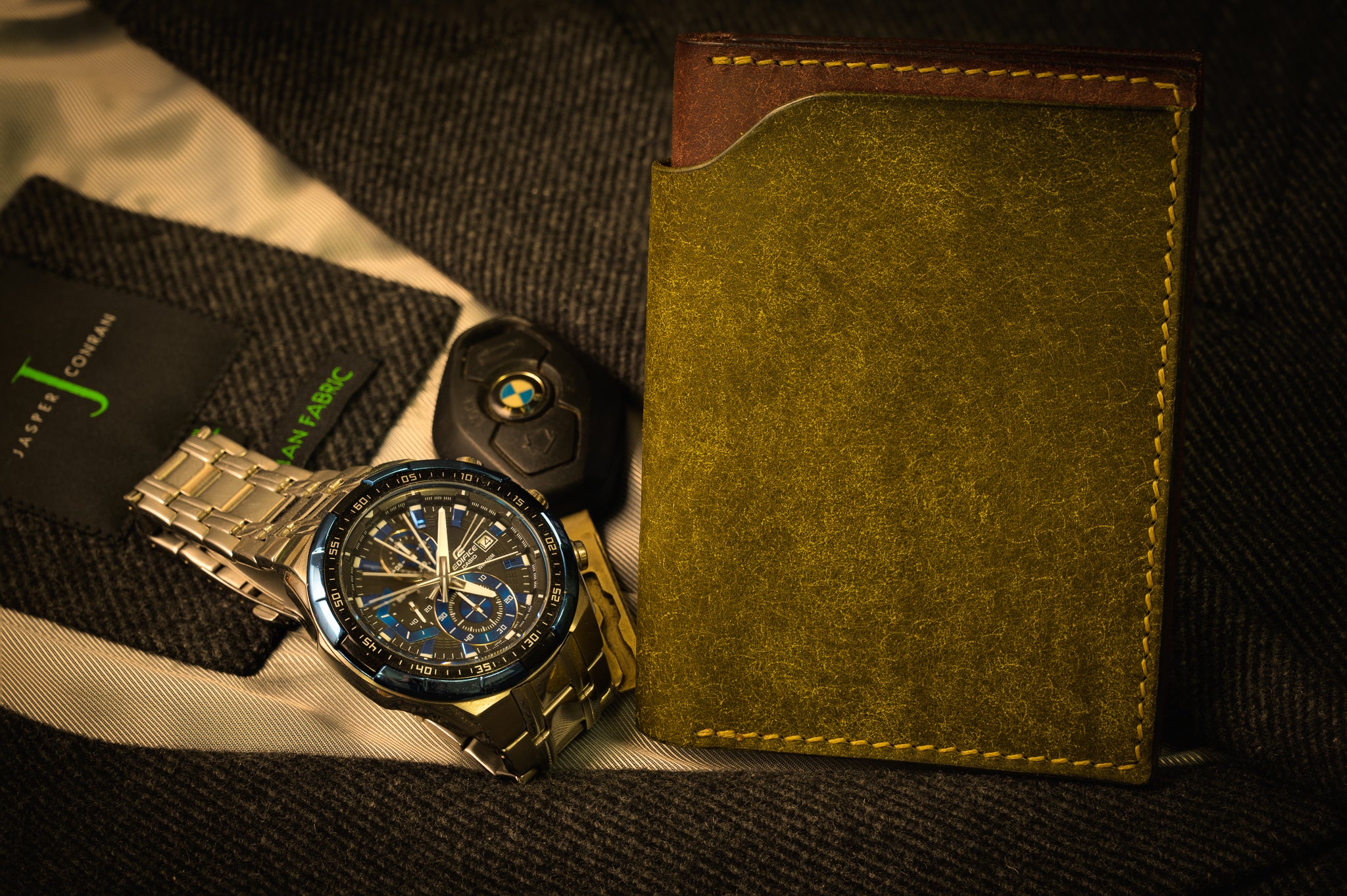Gold watch with intricate design on a dark fabric background