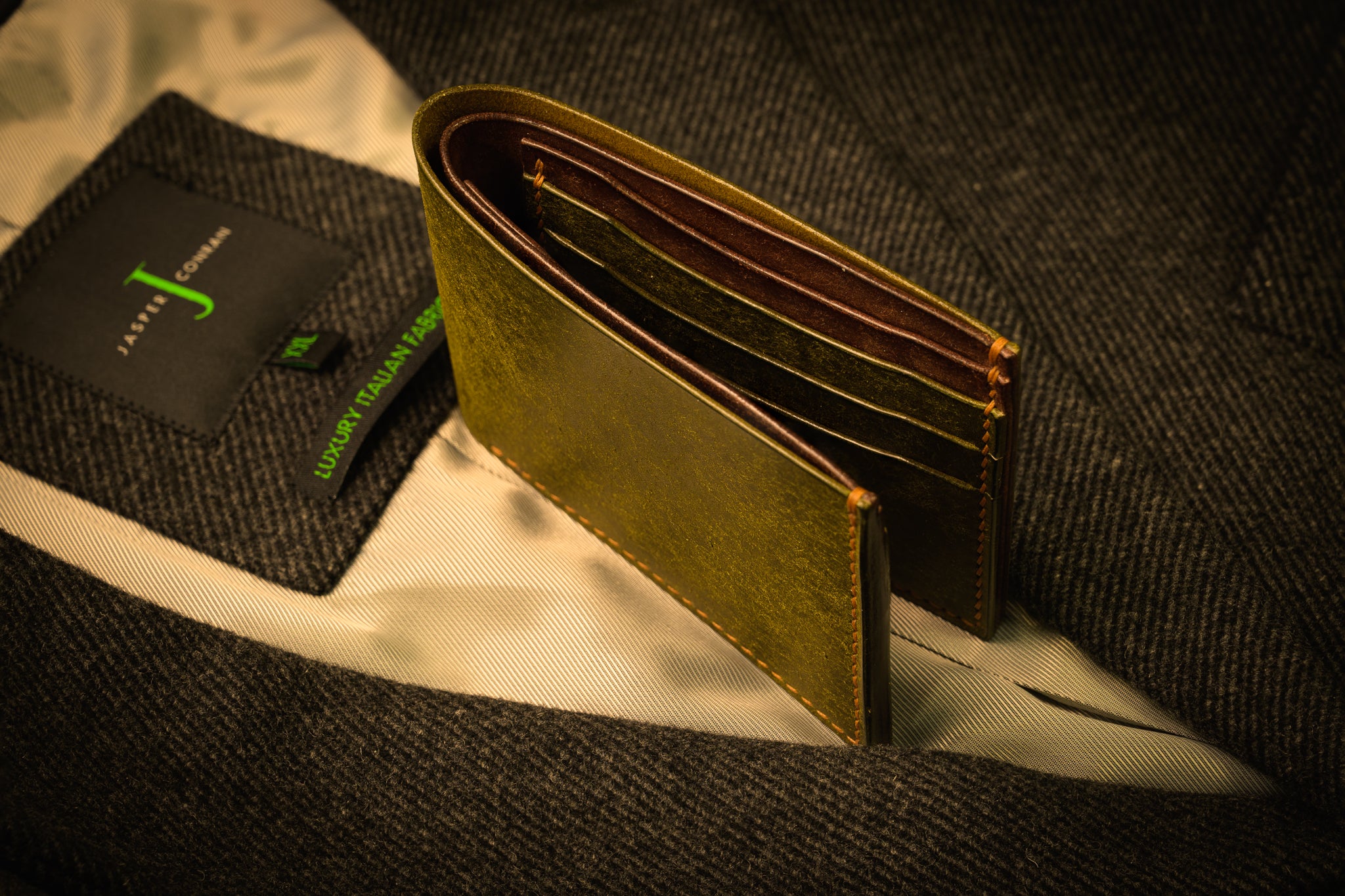 Green leather wallet on a textured surface with a blurred background