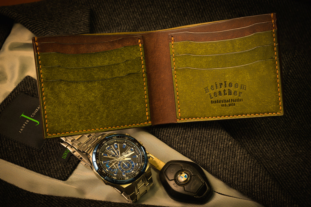 Open leather wallet with a watch and key fob on a textured surface