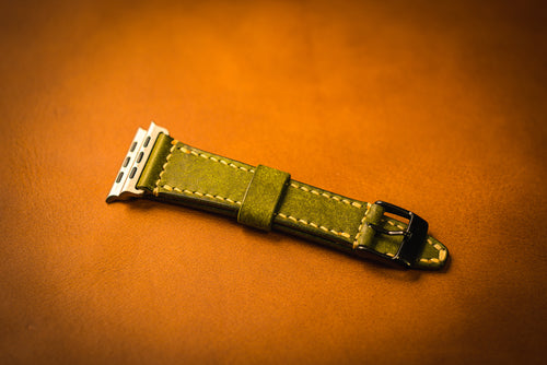 Olive watch strap on a brown background
